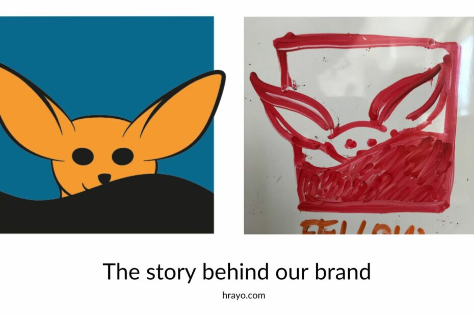 An orange and red fennec fox in a rectangle with his ears sticking our from it.